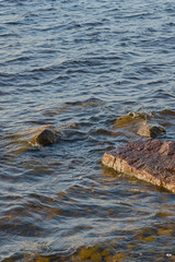 Rocks in water on the coast of a lake. Natural background. Copy space.  