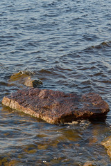 Rocks in water on the coast of a lake. Natural background. Copy space.  