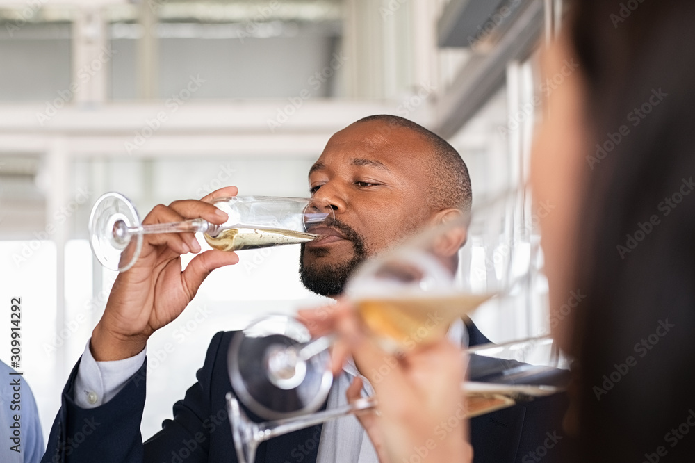 Wall mural business man drinking wine after merger