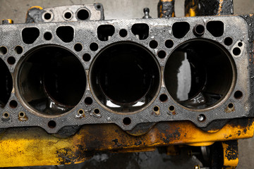 Top view at replacement six cylinder engine used on a floor for installation on a car or tractor after a breakdown and repair in a auto service workshop as a guarantee for the dealership. Auto service