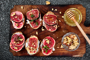 Bruschetta  or ctostini with cottage cheese, figs and honey. Sandwich with figs and goat cheese..