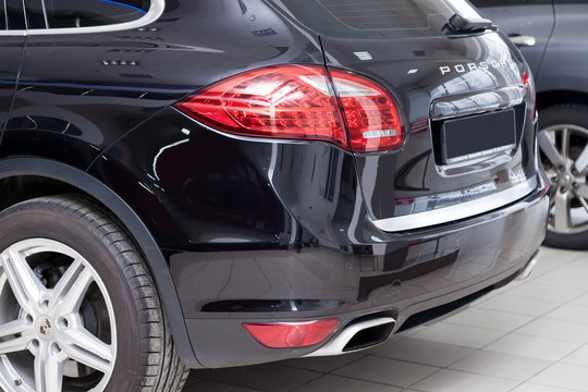 Rear view of Porsche Cayenne Diesel  958 2012 in black color after cleaning before sale in a sunny summer day