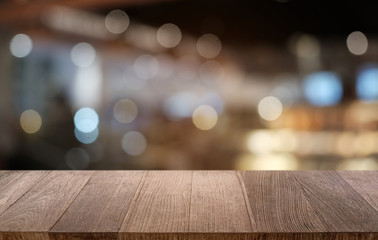 Empty dark wooden table in front of abstract blurred bokeh background of restaurant . can be used for display or montage your products.Mock up for space.