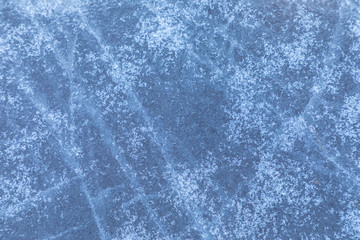 The macro or closeup shot of ice texture or background on the puddle or pool in the frost winter weather