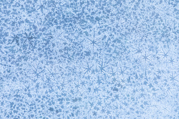 The macro or closeup shot of ice texture or background  with stars on the puddle or pool in the frost winter weather