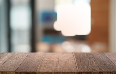 Empty dark wooden table in front of abstract blurred bokeh background of restaurant . can be used for display or montage your products.Mock up for space.