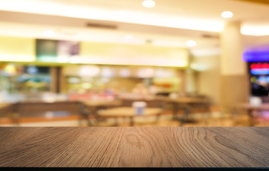 Empty dark wooden table in front of abstract blurred bokeh background of restaurant . can be used for display or montage your products.Mock up for space.