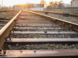 Railway at sunset. Railway station against at sunset. Industrial landscape with a railway. Railway junction. Heavy industry. Evening on the road