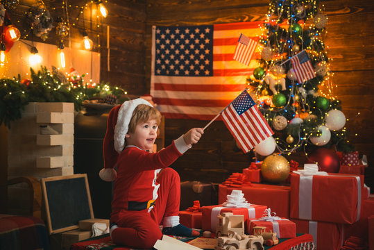 Happy Christmas kid with USA flags. Merry Christmas in America. Christmas with american flag background. Santa helper with american flag.