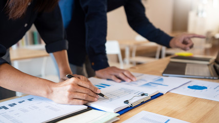 Business People Talking Discussing with coworker planning analyzing financial document data charts and graphs in Meeting and successful teamwork Concept.