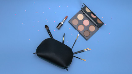 Makeup bag flatlay, with rhinestones spreaded around, can fit for instagram pages