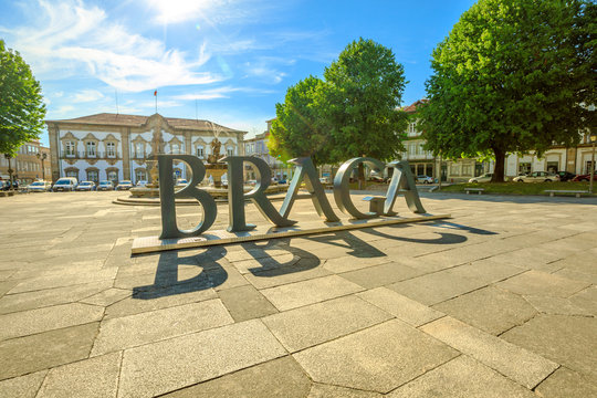 Braga, Portugal - August 12, 2017: Braga Sign or logo of city in Praca do Municipio, Braga downtown, North of Portugal. Braga City Hall on background. Sunny day in the blue sky.