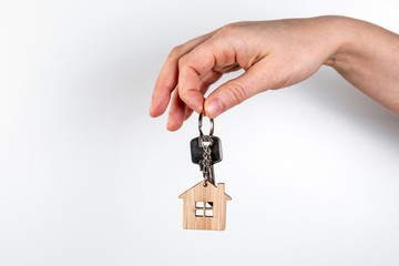 Home keys in women's hands. Real estate and mortgage concept