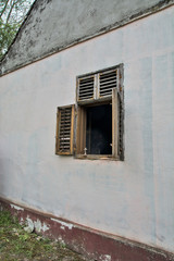 Fototapeta na wymiar Old window with wooden blinds