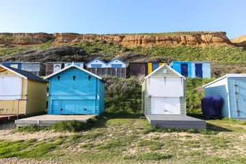 Beach Huts against a sandy cliff in Hampshire, South of England