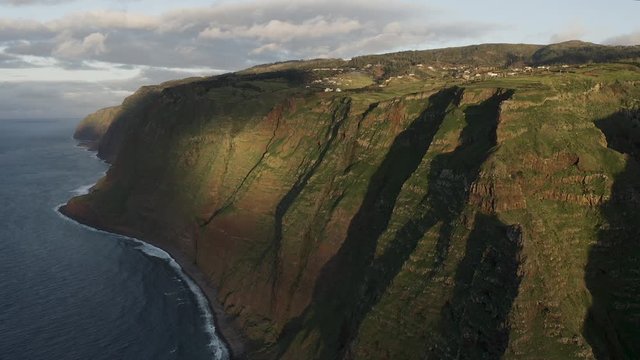 4K aerial view of dramatic tropical coastline by the sea. 
