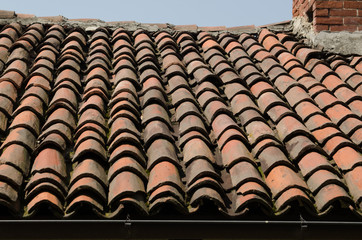 Roof of an ancient house with ancient and old tiles.