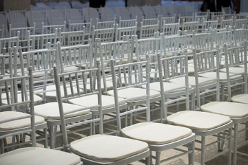 White color coatted on wooden chair Fabric Cloth Empty Many Seats Row Column in Movie Theatre Concert or Siminar Conference room