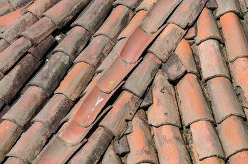 Roof of an ancient house with ancient and old tiles.
