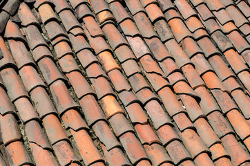 Roof of an ancient house with ancient and old tiles.