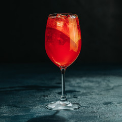 Cocktail aperol spritz on dark background.. Sunlight. Summer alcohol cocktail with orange slices. Italian cocktail aperol spritz