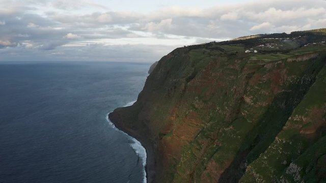 Aerial view of dramatic coastline. Beautiful view of green hills and ocean skyline. 4K
