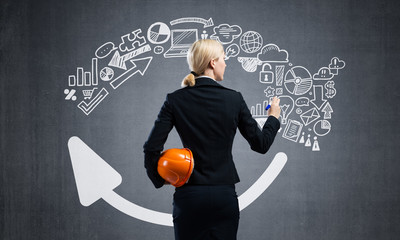 Businesswoman draws various business infographics