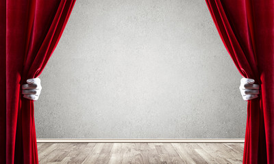 Concrete wall behind drapery curtain and hand opening it