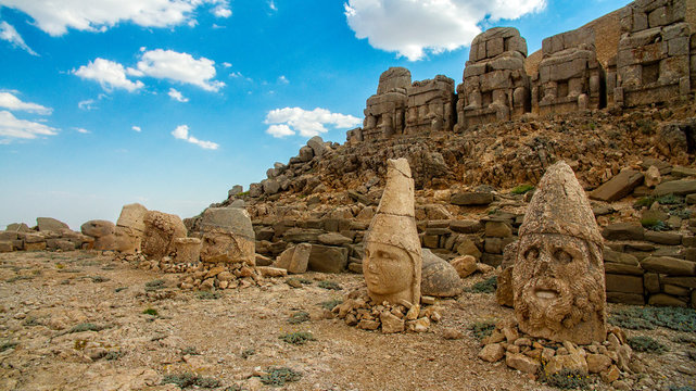 Panoramic view of some of the statues near the peak of Nemrut Dagi. King Antiochus I Theos of Commagene built on the mountain top of Mount Nemrut a tomb-sanctuary flanked by huge statues. Turkey