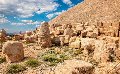 Obraz premium Panoramic view of some of the statues near the peak of Nemrut Dagi. King Antiochus I Theos of Commagene built on the mountain top of Mount Nemrut a tomb-sanctuary flanked by huge statues. Turkey
