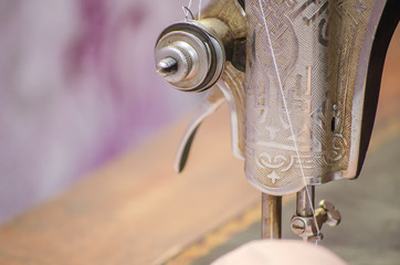 presser foot lift lever, thread tension regulator in sewing machine close-up