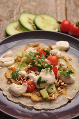 Vegetarian / Vegan Crepes stuffed witg vegetable on wooden table.