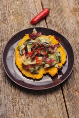 Vegetarian / Vegan Crepes stuffed witg vegetable on wooden table.