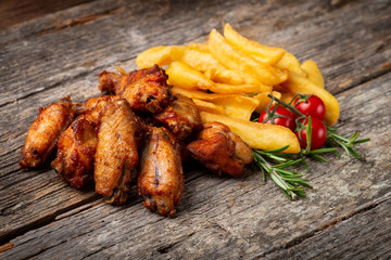 Roasted Chicken with French Fries on the wooden table