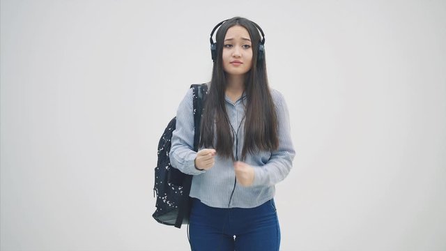 Unfortunate young asian female student moving her hands, as if asking for help.