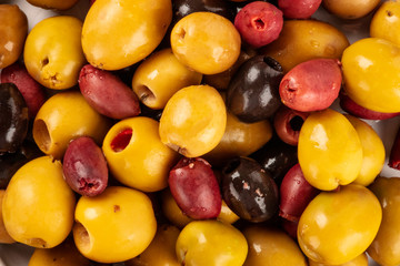 Olives background texture. Black, green and brown olives, an assortment, shot from above