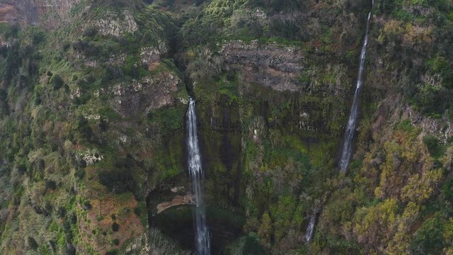 4K aerial view of a waterfall. Shooting from the drone fly over the rain forest and natural stream from waterfall.