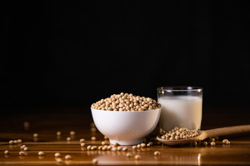 Soy milk hot and soybeans on wooden table background