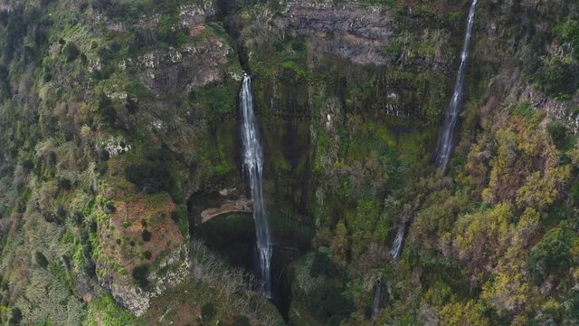 Aerial shot of tropical waterfall in Portugal. Tropical drone scene.