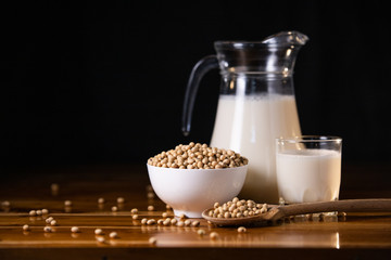 Soy milk hot and soybeans on wooden table background