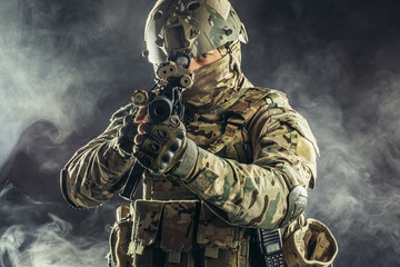 military, army, soldiers concept. brave young soldier prepare to attack holding gun in white foggy...