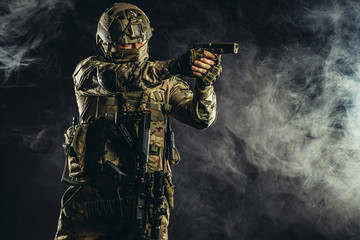 special forces soldier man holding machine gun and military equipment in smoky space