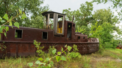 Abandoned ships in the river near of Chernobyl. The abandoned river port in Pripyat. Modern ruins....