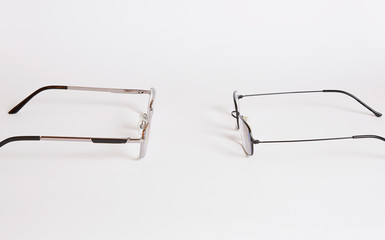 Two pairs of glasses look like people are at each other and want to say something.  Glasses...