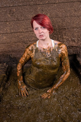 Girl Bathing in cow manure in a manure channel