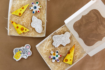 Christmas gingerbread cookies in the form of a mouse with icing set in a box to be painted. Christmas fun for kids.