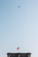 helicopter flying over a bridge