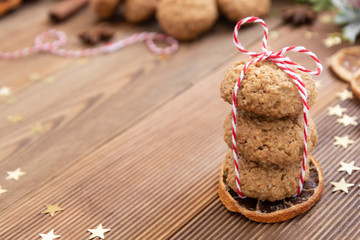 Stack of homemade oatmeal cookies. Christmas healthy cookies, biscuits. Rustic wooden table. Winter decoration.