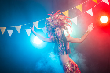 Carnival, belly dance and holiday concept - Beautiful female samba dancer wearing gold costume and...