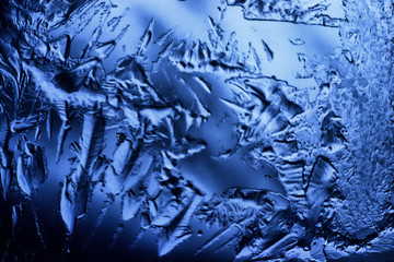 blue ice glass background, abstract texture of the surface of the ice on the glass, frozen seasonal water
